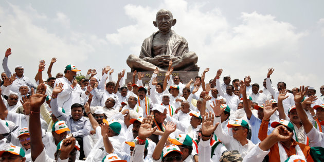Lawmakers from India's main opposition Congress party and the Janata Dal (Secular) protest against India's ruling Bharatiya Janata Party (BJP) leader B.S. Yeddyurappa's swearing-in as Chief Minister of the southern state of Karnataka, in Bengaluru, India, May 17, 2018. REUTERS/Abhishek N. Chinnappa