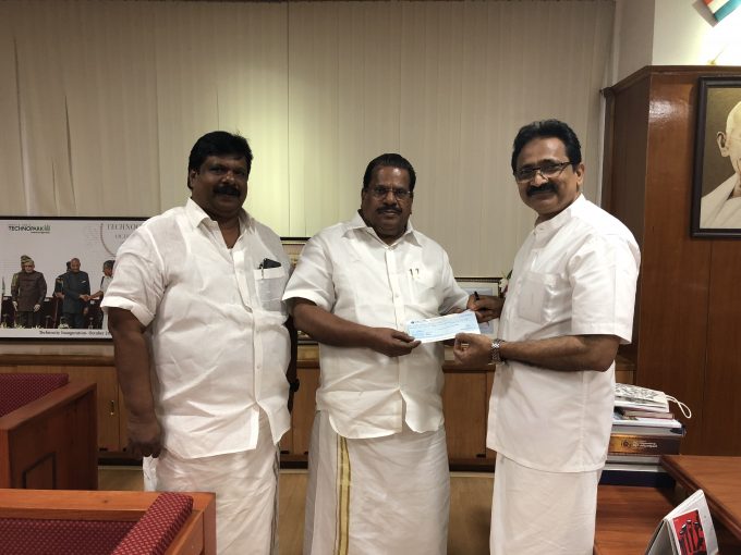 NA Muhammed Kutty handing over the cheque to Industries Minister EP Jayarajan
