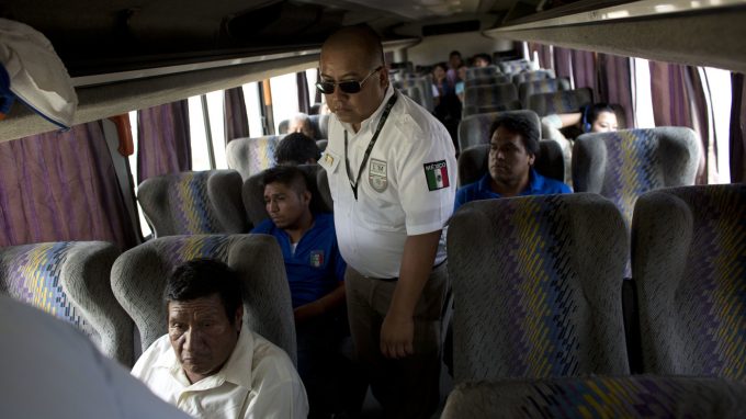An immigration official checks a bus for Central American migrants at a roadblock north of Arriaga, Chiapas state, Mexico. In recent years the country has apprehended and deported more Central American migrants than the U.S. has.